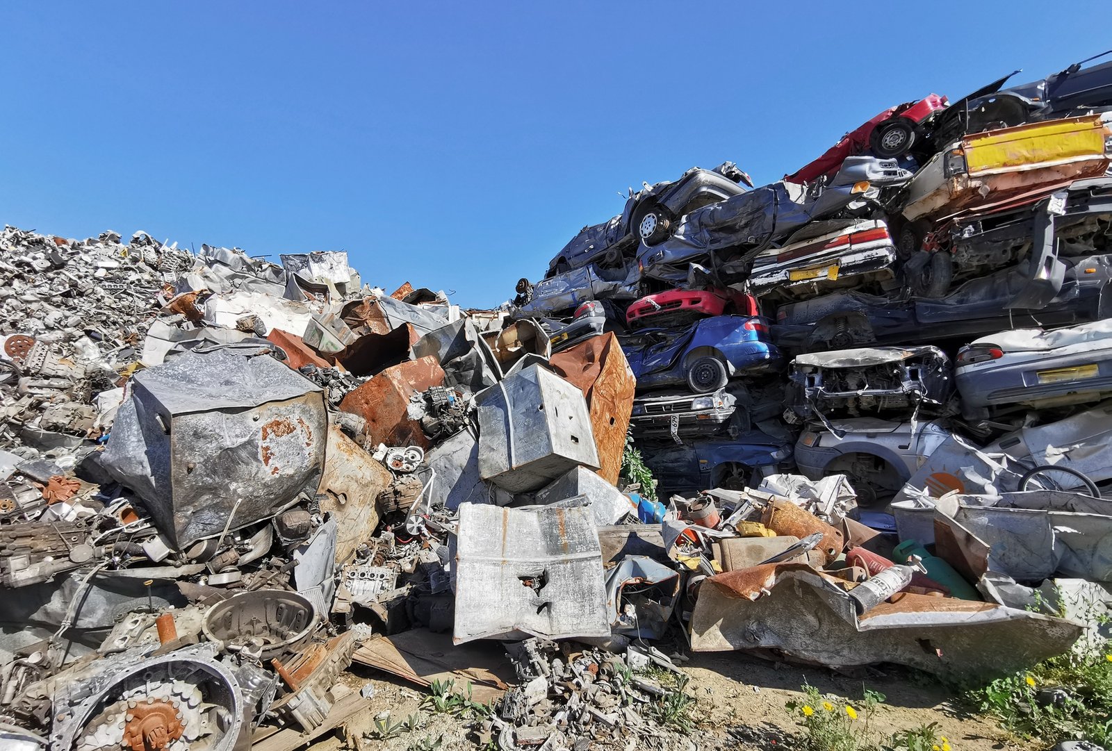 Pile of scrap cars and other metals on a junk yard ready recycling industry.